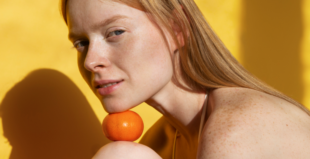 Primer plano de rostro femenino con piel radiante y tono uniforme tras una rutina con vitamina C