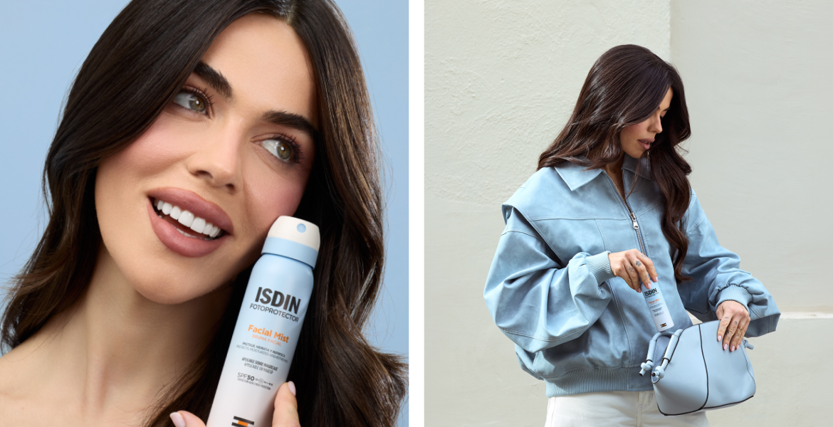 Violeta Mangriñan sosteniendo ISDIN Facial Mist SPF 50 junto al rostro y guardando el producto en un bolso azul.