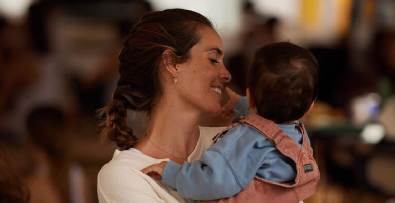 Ona Carbonell sonríe mientras sostiene a un bebé en brazos, reflejando su faceta familiar y su vida fuera del deporte.