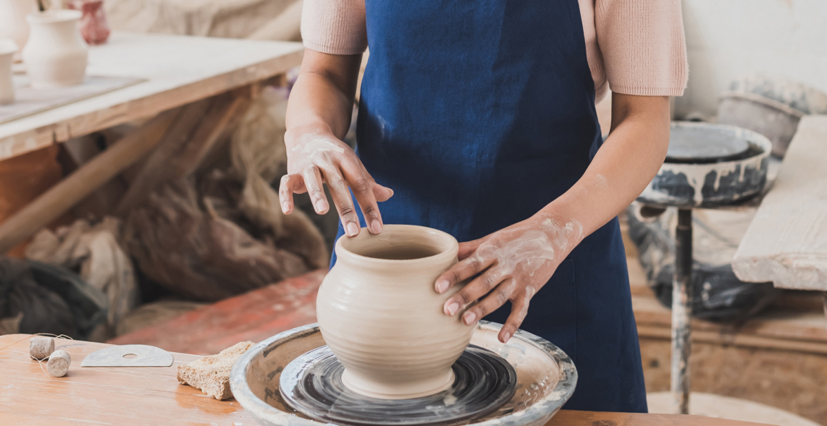 Woman doing ceramics on wheel