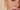 Extreme close-up of a person’s cheek with freckles and smooth skin texture under natural lighting.