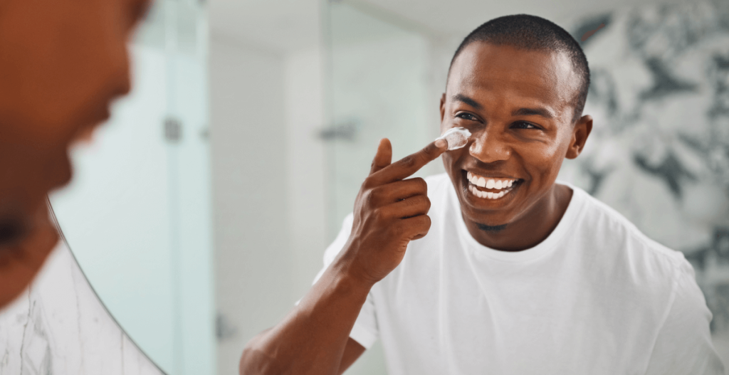 Man putting face cream on
