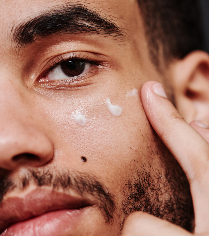 Man applying eye cream for bags
