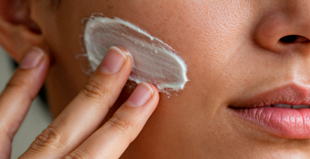 Woman applying moisturizer