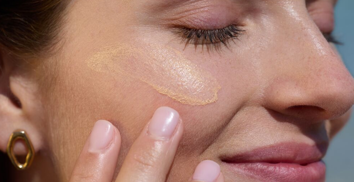 SPF Glossary woman with sunscreen